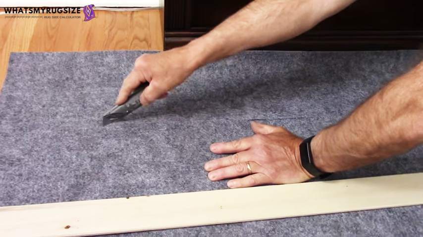 Continue to cut along the marked lines on rug pad